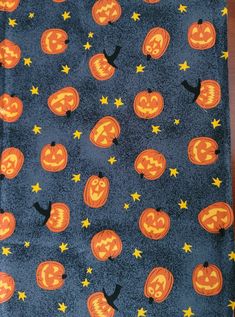 an orange and black halloween themed design on a blue background with stars, pumpkins and jack - o'- lanterns