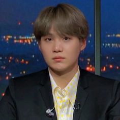 a man in a suit and tie sitting down