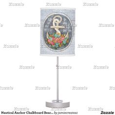 a lamp with an anchor and flowers on the bottom is shown in front of a white background