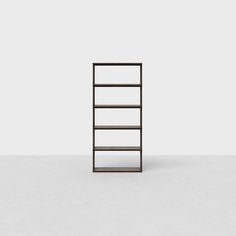 an empty book shelf sitting on top of a white floor