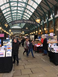 people are walking through an indoor market area