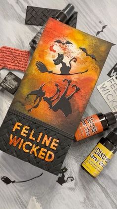 an assortment of halloween items on a table with the words feline wickend