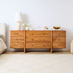 a wooden dresser sitting on top of a white rug