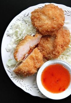 fried chicken and coleslaw on a plate with dipping sauce