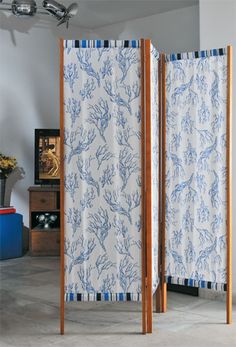 the room divider is decorated with blue and white designs