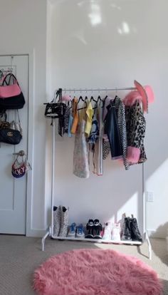 there is a rack with shoes and purses on it in the corner of this room