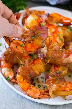 a plate with shrimp skewers and garnished with parsley