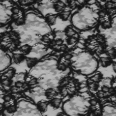 Fall in love with is gorgeous black floral lace fabric perfect for luxurious evening gowns and dresses. In a classic black coloration, this floral lace fabric is filled with a frenzy of roses corded for added textural interest. Laying at 54" in width and completely sheer, let this lace material make a huge impact on your over-all wardrobe or collection in the form of riveting gowns, jackets and overlays. Use this timeless lace fabric and layer it on top of a sateen for a night out on the town or Black Lace With Lace Closure For Evening, Fitted Black Lace Dress With Lace Work, Black Stretch Lace Dress, Party Black Lace With Contrast Detail, Black Lace Dress With Lace Work, Elegant Black Lace Dress With Lace Closure, Black Lace With Patchwork For Evening, Black Lace Dress For Wedding, Black Scalloped Lace For Evening