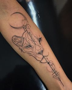 a tattoo on the arm of a woman with a wolf head and arrow in it