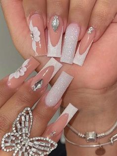 a woman's hands with white and pink nail designs