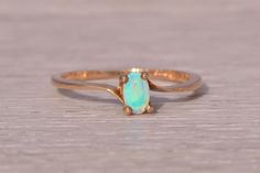 a gold ring with an opal stone on it