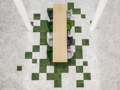 an overhead view of a table and chairs in a room with checkered flooring