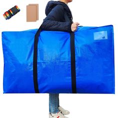 a man carrying a large blue bag with the handles down