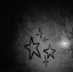 a black and white photo with stars drawn on it