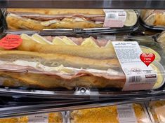 deli meats in plastic containers with labels on them for sale at a grocery store