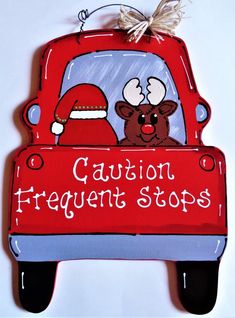 a red truck with a santa clause on it's hood and the words caution frequent stops