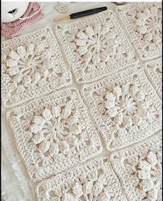 a crocheted blanket is laying on a table