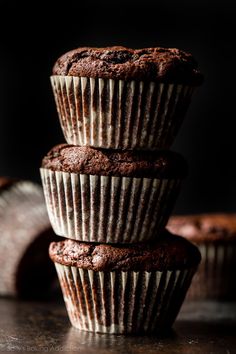 three chocolate muffins stacked on top of each other