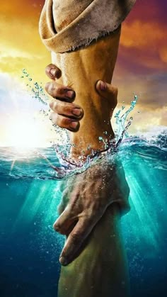 two hands holding each other in the water