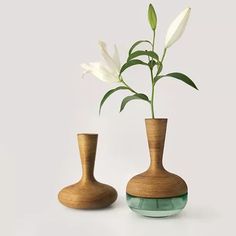 two wooden vases with white flowers in them