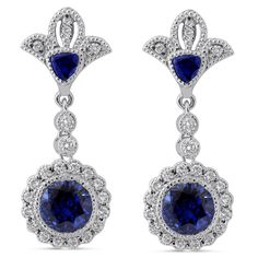 Two dazzling round cut medium blue sapphires are bezel set in this unique royal style drop down earring mounting with round cut diamonds and hand engraved fine milgrain accents. 
 
  These earrings are custom made to order and can be modified to fit your needs  .      MAIN GEM   Gem: Sapphire 
 Shape: Round 
 Carat Weight: 6ctw 
 Size: 7mm 
 Color: Medium Blue Dark Blue 
 Clarity: 
 Earring Style: Screw Back 
 Earring Style: Screw Back    ACCENT STONES   Gem: Diamond 
 Shape: Round 
 Carat Weight: 1.00ctw 
 Color: H 
 Clarity: SI1    ADDITIONAL INFORMATION   Style #: ER201 
 Additional Information: These earrings are customizable and can be modified to fit your needs Gem Gem, Blue Sapphire Diamond, Royal Style, Best Diamond, Screw Back Earrings, Style Earrings, Royal Fashion, Diamond Shape, Sapphire Diamond