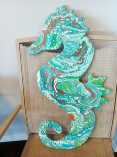 a sea horse made out of paper on a chair