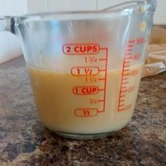 a measuring cup filled with liquid on top of a counter