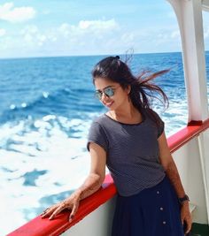 a woman standing on the deck of a boat