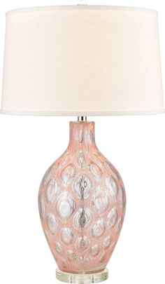 a pink glass lamp with a white shade