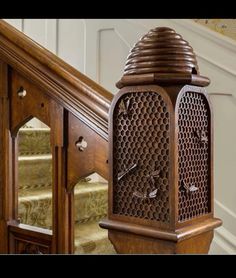 an ornate wooden clock sitting on top of a stair case