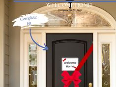 a welcome home sign is attached to the front door of a house with a red ribbon