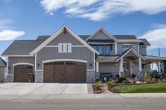 a large house with two garages on the front