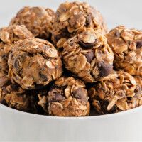 a white bowl filled with chocolate chip granola balls