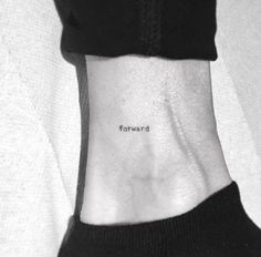 a woman's wrist with the word forward tattooed on her left side ribcage