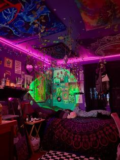 a bedroom with purple and green lights on the ceiling