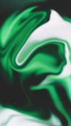 an abstract green and white painting on a black background with the image of a swirly substance