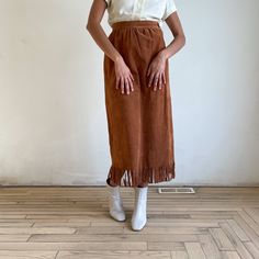 "This is a tan suede skirt with fringe from the 90s. Perfect for daily western chic. Dead-stock tags still attached with original price of $325. \"Country Shop Marshall Fields\" label tag Fits Small Waist 28\" Hip 42\" Length 37\" 100% Pigsuede Excellent condition with deadstock tags" Bohemian Brown Bottoms With Fringe, Bohemian Brown Fringe Bottoms, Chic Brown Fringe Skirt, Fall Pencil Skirt With Fringe, Tan Suede Skirt, Long Skirt Outfit, Maxi Rock, Skirt With Fringe, Marshall Fields