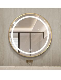 a bathroom with a round mirror on the wall