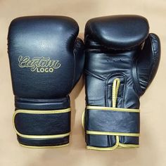 two black boxing gloves sitting on top of each other