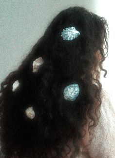 the back of a woman's head with blue and white polka dots on it