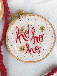 a hand embroidered hoop with the words hello, one on it and stars in red thread