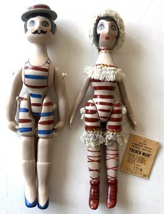 two dolls that are standing next to each other