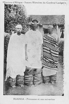 two women standing next to each other in front of a building