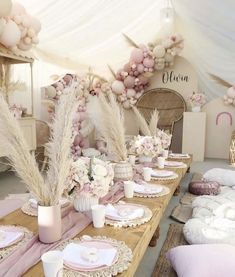 the table is set with pink and white decorations