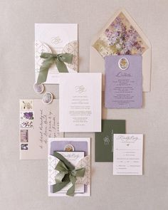 the wedding stationery is laid out on top of each other