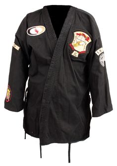 a black karate jacket with patches on it