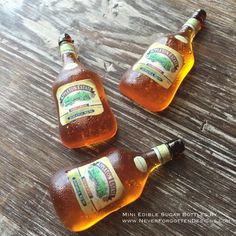 three bottles of beer sitting on top of a wooden table