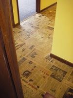 an open door leading to a hallway with yellow walls and floor tiles on the ground