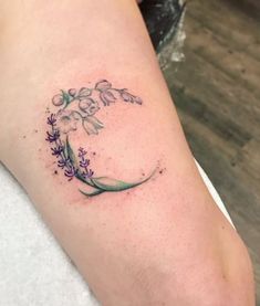 a woman's arm with a flower tattoo on the left side of her leg