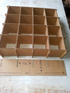 several cardboard boxes sitting on top of a table next to a ruler and tape measure